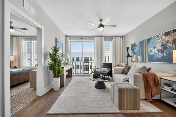 Bright and inviting living room with modern decor, plush sofa, and large windows offering expansive views and abundant natural light.