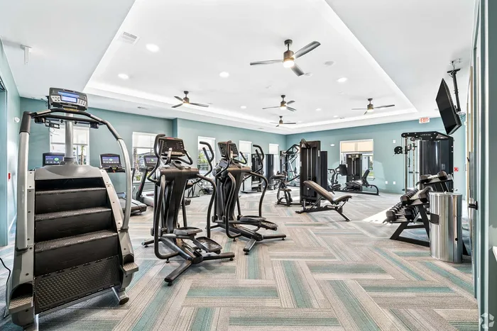 State-of-the-art fitness center featuring modern cardio machines, weight training equipment, and sleek design.