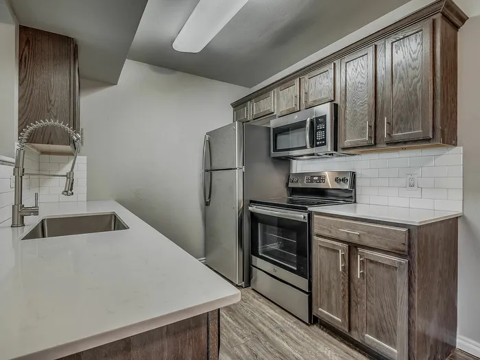 Stylish kitchen with stainless steel appliances, sleek countertops, and contemporary cabinetry.