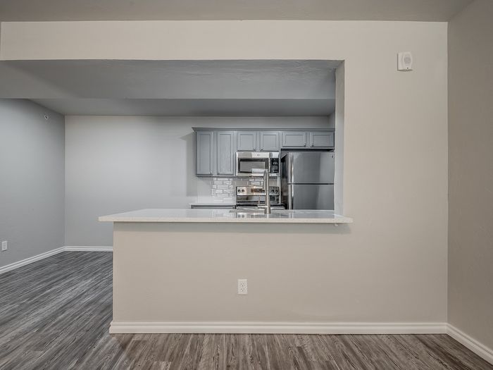 Sleek modern kitchen with stainless steel appliances and a stylish open countertop design.