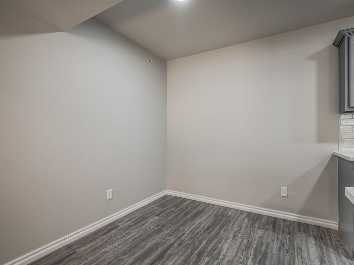 Bright corner space with modern gray flooring and white walls.