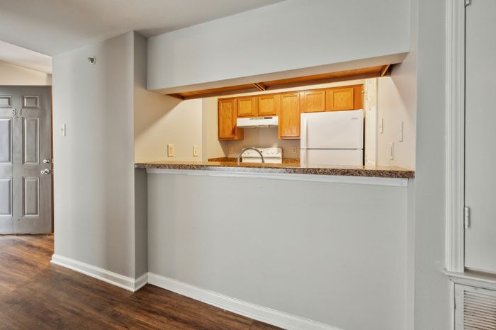 Inviting open kitchen design featuring wooden cabinetry, sleek countertops, and modern appliances for a stylish living experience.
