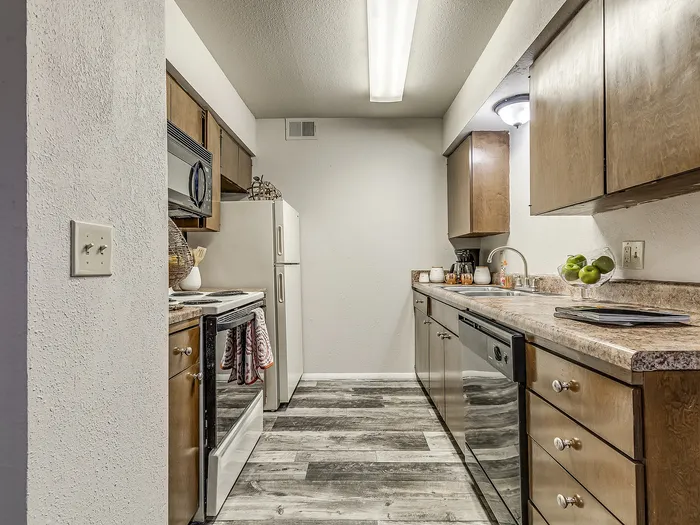 Modern kitchen with sleek appliances, ample cabinetry, and elegant countertops, perfect for culinary enthusiasts.