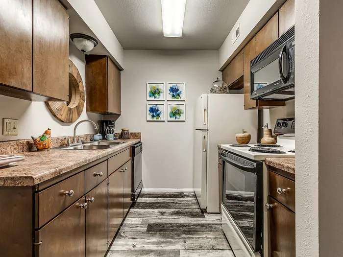 Charming and modern kitchen with sleek wooden cabinetry, marble countertops, and stainless steel appliances, perfect for culinary creativity.