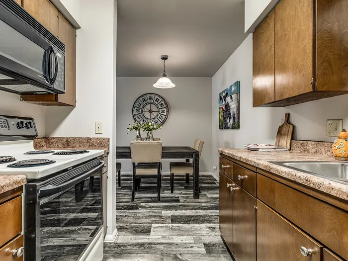 Charming kitchen with modern appliances and a stylish dining area featuring elegant decor and rustic wood finishes.