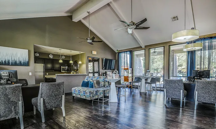 Modern communal area with sleek furnishings, high ceilings, and ample natural light, perfect for social gatherings and relaxation.