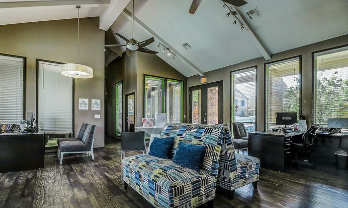 Inviting modern office space with high ceilings, recessed lighting, and large windows offering abundant natural light.