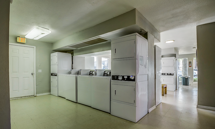 Spacious communal laundry room offering modern, efficient washers and dryers for resident convenience.