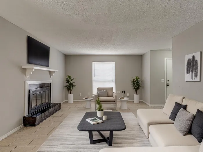 Inviting living room with modern fireplace, cozy seating, and elegant decor.