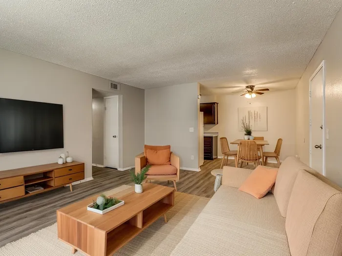 Inviting living space with modern furniture, cozy seating, and a sleek dining area, perfect for relaxation and entertaining.