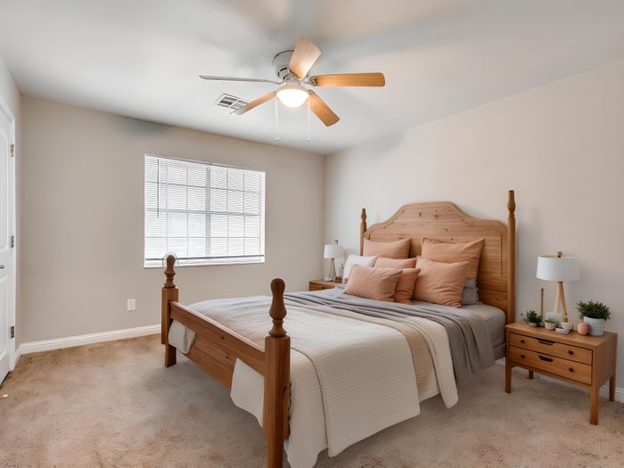 Inviting bedroom with cozy wooden bed frame, plush pillows, and ambient lighting, bathed in natural sunlight.