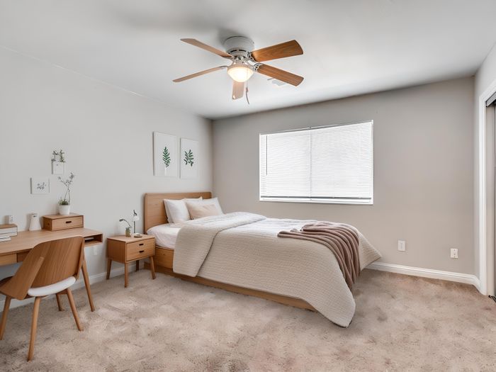 Bright and modern bedroom with cozy bedding, elegant wooden furniture, and a soothing neutral palette.