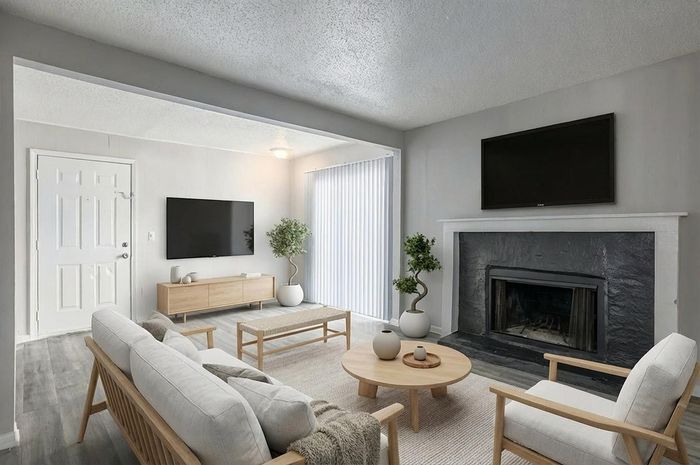 Bright and welcoming living room with modern decor, featuring elegant wood furniture, a sleek TV setup, and a charming fireplace. Perfect for cozy evenings and stylish entertaining.