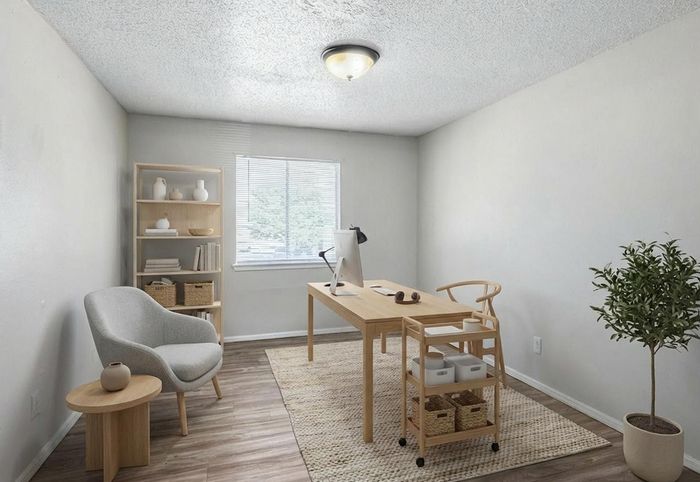 Bright and inviting home office with modern decor, featuring a sleek desk, comfortable chair, and natural light from a large window.