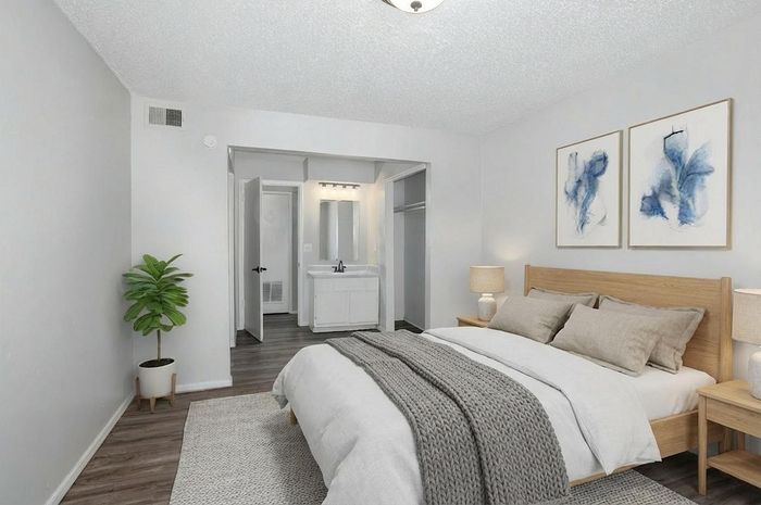Elegant bedroom showcasing a cozy, well-lit space with modern decor, featuring a comfortable bed, stylish artwork, and a relaxing ambiance.