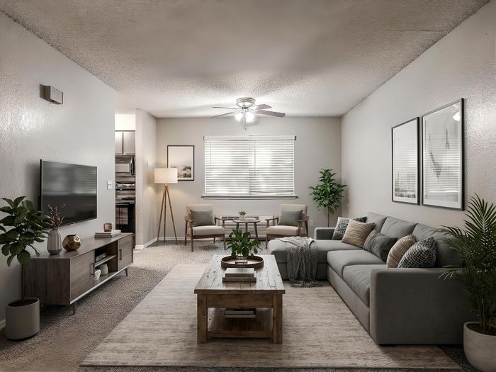 Elegant living room with modern decor, featuring a cozy gray sectional sofa, stylish wooden coffee table, wall-mounted TV, and abundant natural light.