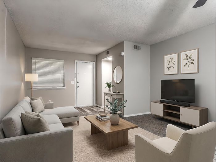 Chic living room with modern gray sectional, sleek wooden coffee table, and elegant decor, exuding cozy elegance and style.