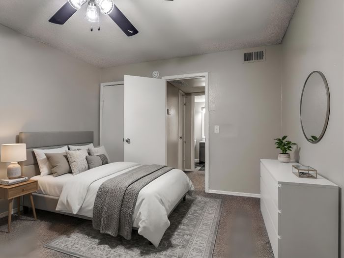 Cozy bedroom featuring elegant decor with plush bedding, ambient lighting, and modern furnishings.