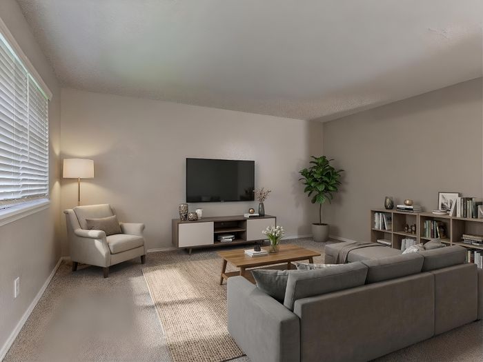 Elegant living room with plush armchair, modern sofa, and TV unit, enhanced by a large window and stylish decor, perfect for relaxation and entertainment.