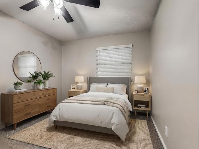 Elegant bedroom with cozy ambiance, featuring plush bedding, stylish wooden furniture, and a soothing neutral palette.