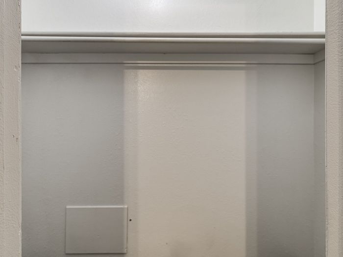 Bright and spacious closet with built-in shelving, perfect for organized storage.