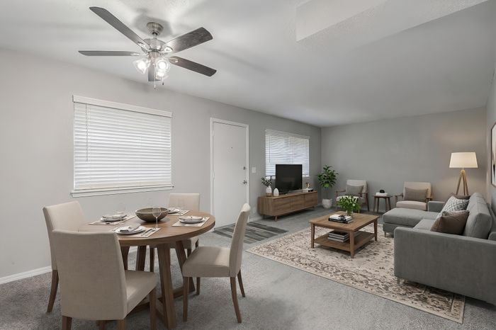 Bright and inviting living space featuring modern decor, a comfy sofa, and a stylish dining area, perfect for entertaining.