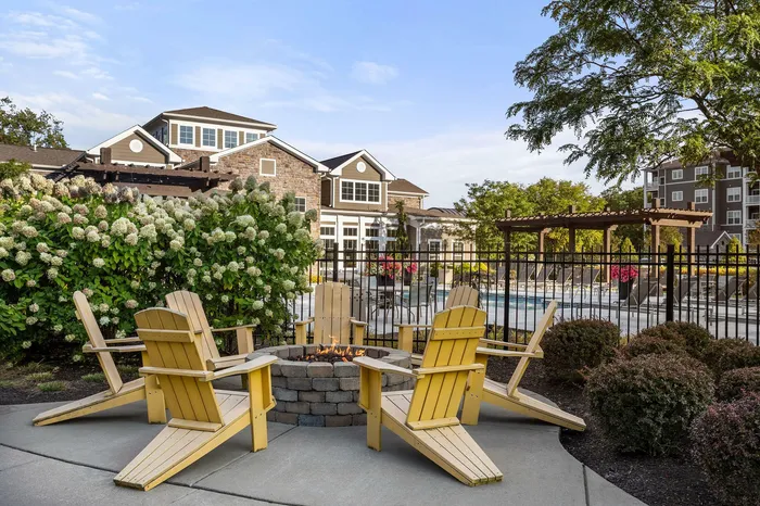 Fire pit with yellow adirondack chairs