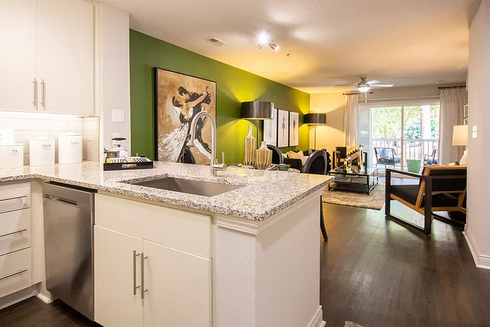 Bright and modern open-concept kitchen and living area with stylish decor and a view of a balcony.