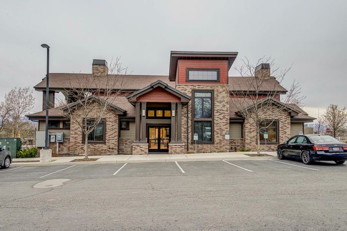Charming brick façade of a residential building with modern design elements and inviting entrance, set in a peaceful suburban location.