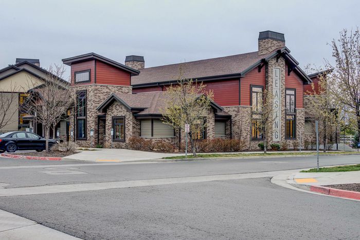 Inviting leasing office with modern brick facade and lush landscaping, perfect for welcoming new residents.