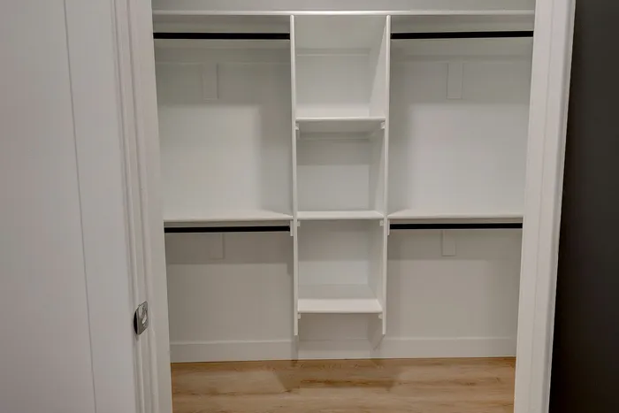 Spacious walk-in closet with versatile shelving and ample storage, perfect for an organized lifestyle.
