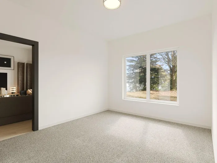 Bright and cozy room with a large window offering a serene view of the trees, perfect for relaxation and inspiration.
