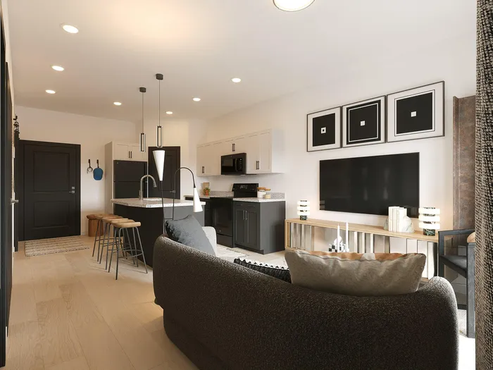 Modern open-plan living space featuring sleek kitchen with island, cozy lounge area, and elegant decor.