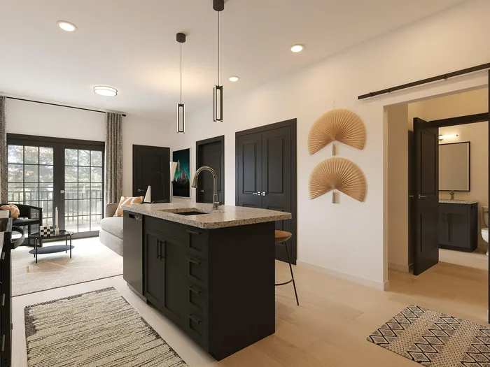 Elegant open-concept apartment showcasing a modern kitchen with island, sleek living area, and stylish décor.