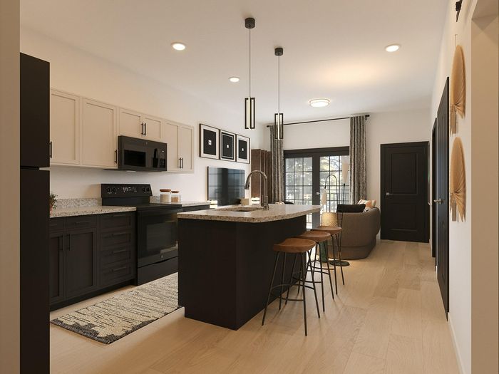 Contemporary kitchen showcasing elegant dark cabinetry, sleek countertops, and a cozy breakfast bar, leading into a stylish open-concept living area.