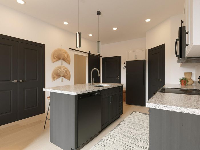 Modern kitchen with sleek dark cabinetry, granite countertops, and stylish pendant lighting, featuring double doors and artistic wall decor.