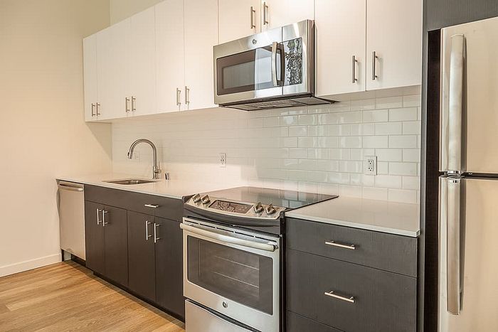 Modern kitchen featuring sleek cabinetry, stainless steel appliances, and elegant countertops, offering a stylish and functional space.