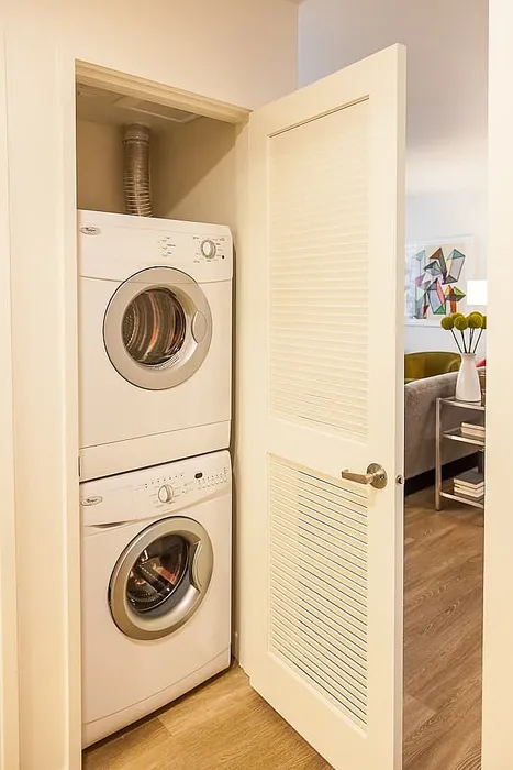 Convenient in-unit laundry with modern stacked washer and dryer, enhancing this apartment's functionality.