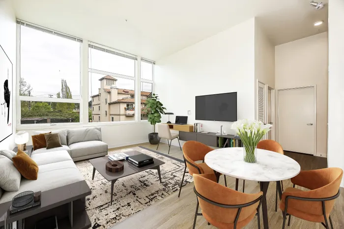 Bright and airy living room with large windows, stylish modern furniture, and a cozy decor, perfect for relaxation and entertaining.