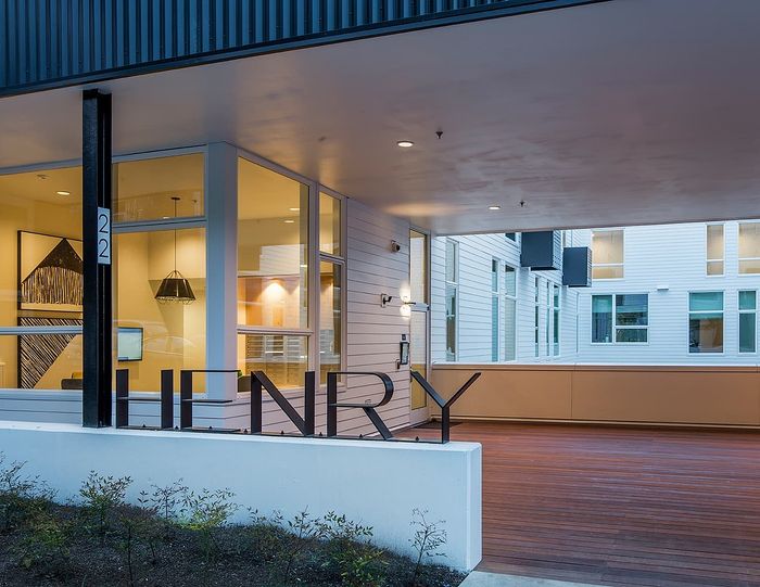 Modern apartment entrance with stylish decor, featuring large windows for ample natural light.