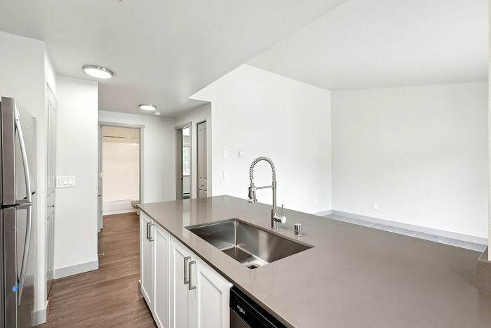 Modern kitchen design with sleek stainless steel appliances, elegant countertops, and ample natural light.