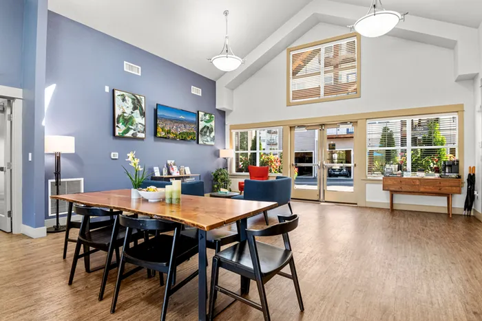 Inviting open-concept living space with modern dining area, high ceilings, and abundant natural light.
