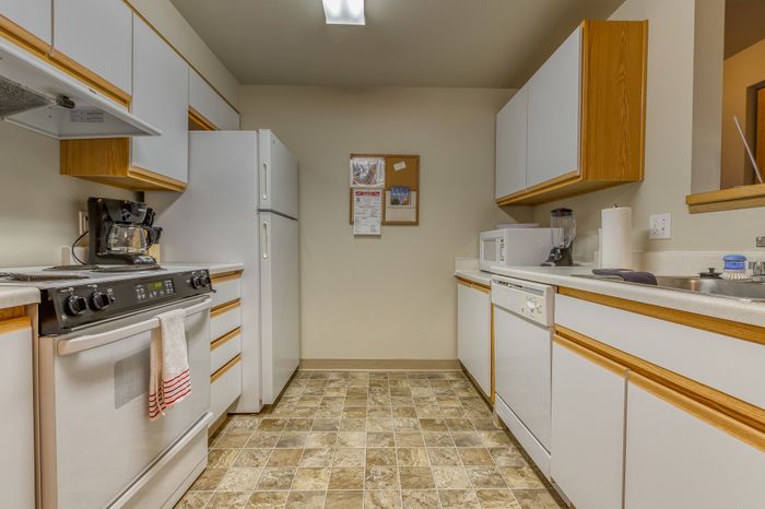 Bright and functional kitchen with modern appliances and ample storage, perfect for culinary enthusiasts.
