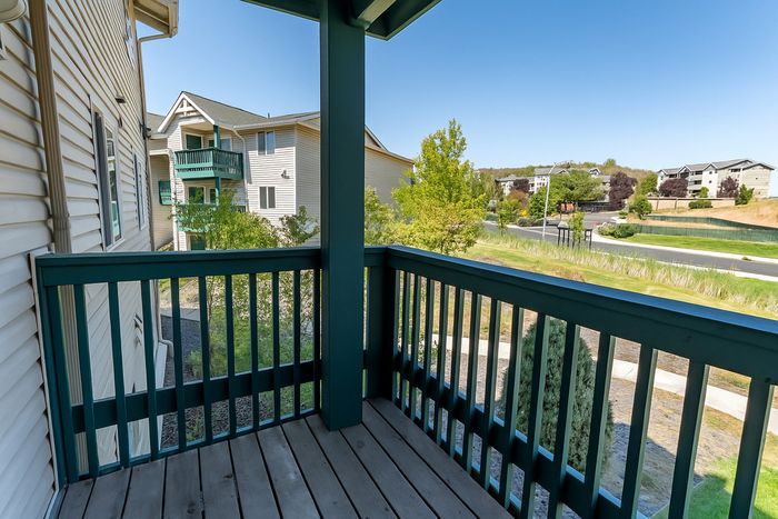 Charming balcony view with vibrant greenery, providing a peaceful outdoor space in a modern apartment complex.