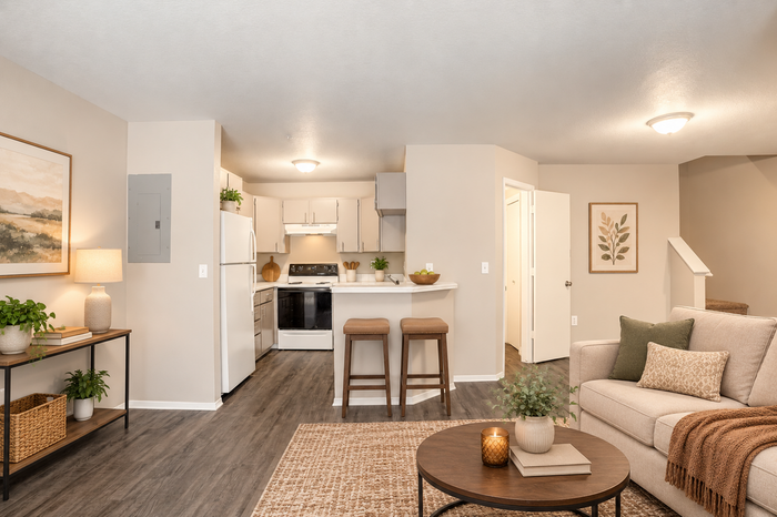Inviting open-concept living space featuring a contemporary kitchen, cozy seating area, and stylish decor with warm, neutral tones.