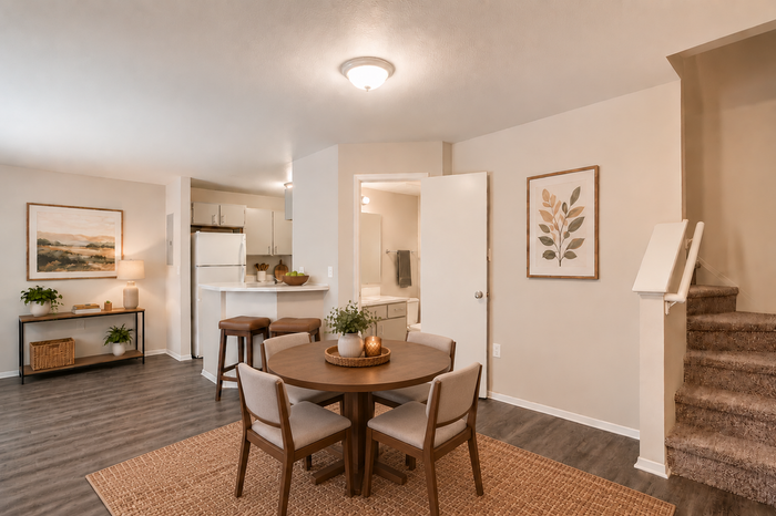 Inviting open-concept dining area with elegant decor, cozy seating, and a bright kitchen, perfect for modern living.
