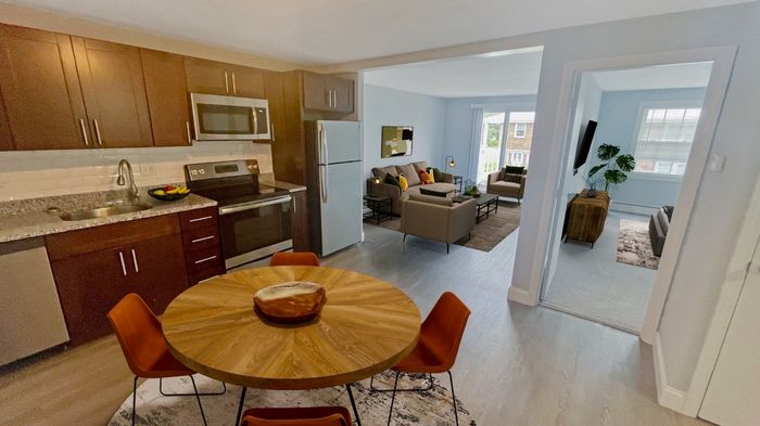 Open concept apartment with modern kitchen, dining area, and spacious living room at Winchester Arms in Dover, New Hampshire