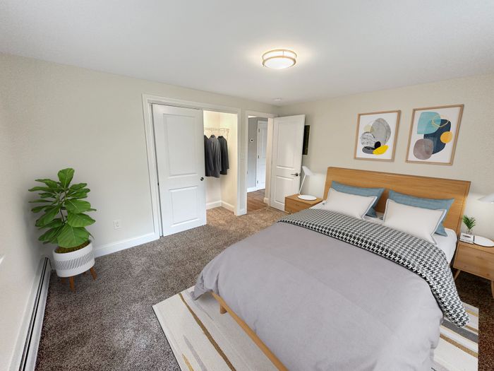 Spacious bedroom with large closet, soft carpet flooring, and modern furnishings at Westgate Arms in Salem, New Hampshire