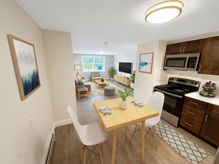 Open-concept kitchen and living area with dining table, modern appliances, and natural light at Westgate Arms in Salem, New Hampshire