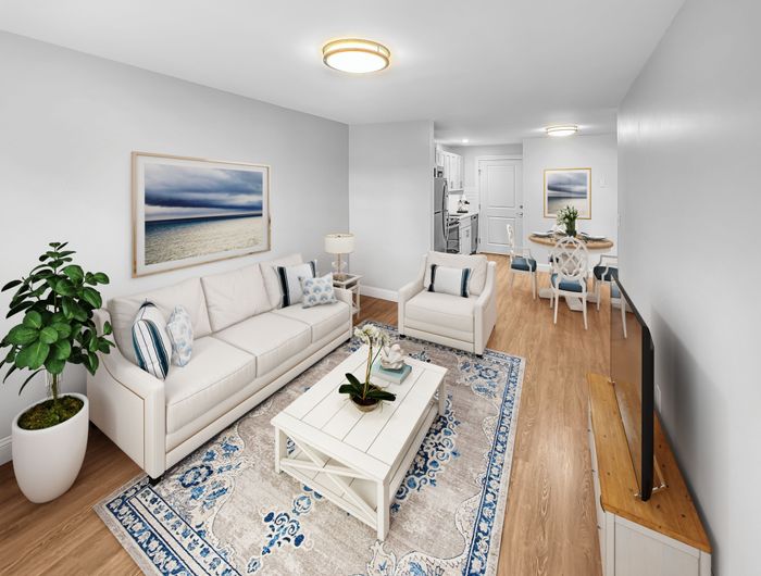 Open concept living room and dining area with hardwood-style flooring and modern finishes at Westgate Arms in Salem, New Hampshire